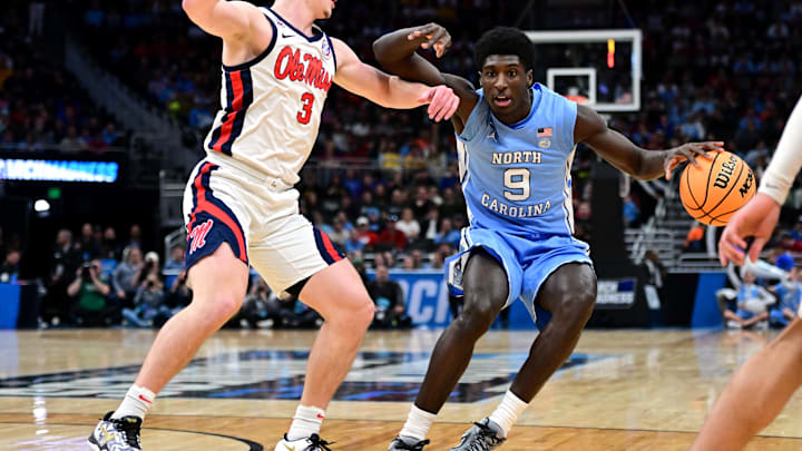 Mar 21, 2025; Milwaukee, WI, USA; North Carolina Tar Heels guard Drake Powell (9) drives against Mississippi Rebels guard Sean Pedulla (3) during the first half of a first round NCAA men’s tournament game at Fiserv Forum. Mandatory Credit: Benny Sieu-Imagn Images