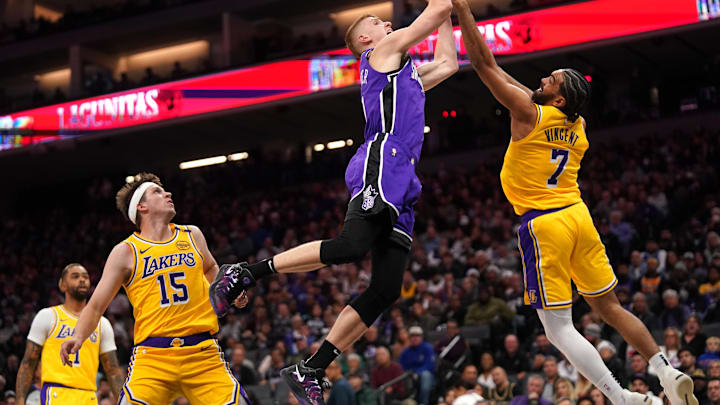 Dec 19, 2024; Sacramento, California, USA; Sacramento Kings guard Kevin Huerter (9) is fouled by Los Angeles Lakers guard Gabe Vincent (7) in the third quarter at the Golden 1 Center. Mandatory Credit: Cary Edmondson-Imagn Images