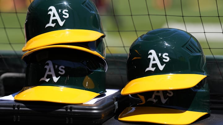 May 29, 2022; Oakland, California, USA; Oakland Athletics helmets are stacked near the field before the game against the Texas Rangers at RingCentral Coliseum. Mandatory Credit: Darren Yamashita-Imagn Images