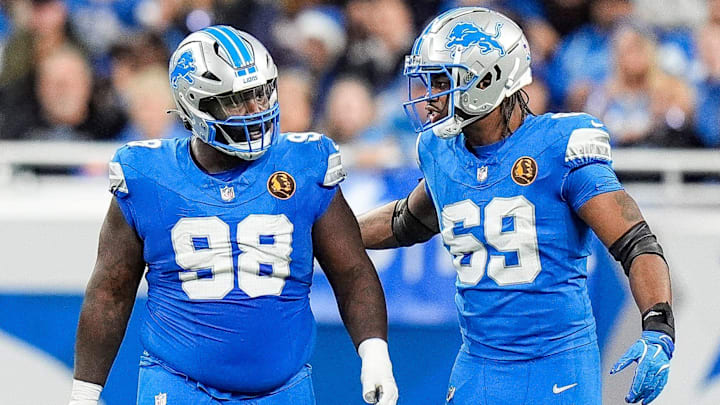 Detroit Lions defensive tackle DJ Reader (98) and linebacker Al-Quadin Muhammad (69) celebrates a play against Chicago Bears during the second half at Ford Field in Detroit on Thursday, Nov. 28, 2024.