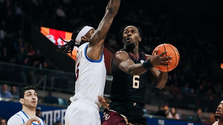 Florida State Seminoles guard Robert McCray V (6) attempts a layup against SMU Mustangs guard B.J. Edwards (5) | January 24, 2026
