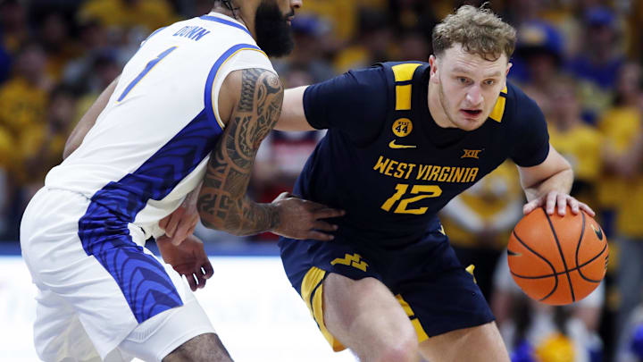 West Virginia Mountaineers guard Tucker DeVries (12) brings the ball up court against pressure from Pittsburgh Panthers guard Damian Dunn (1) during the first half at the Petersen Events Center. West Virginia Mountaineers guard Tucker DeVries (12) brings the ball up court against pressure from Pittsburgh Panthers guard Damian Dunn (1) during the first half at the Petersen Events Center.