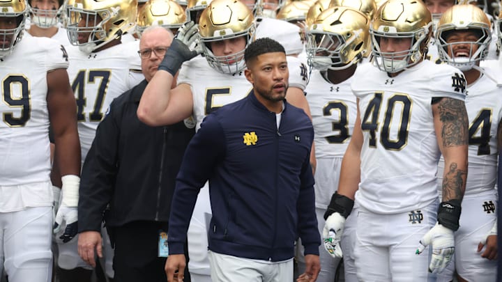 Nov 15, 2025; Pittsburgh, Pennsylvania, USA; Notre Dame Fighting Irish head coach Marcus Freeman (middle) leads the team onto the field to play the Pittsburgh Panthers at Acrisure Stadium. Mandatory Credit: Charles LeClaire-Imagn Images Nov 15, 2025; Pittsburgh, Pennsylvania, USA; Notre Dame Fighting Irish head coach Marcus Freeman (middle) leads the team onto the field to play the Pittsburgh Panthers at Acrisure Stadium. Mandatory Credit: Charles LeClaire-Imagn Images