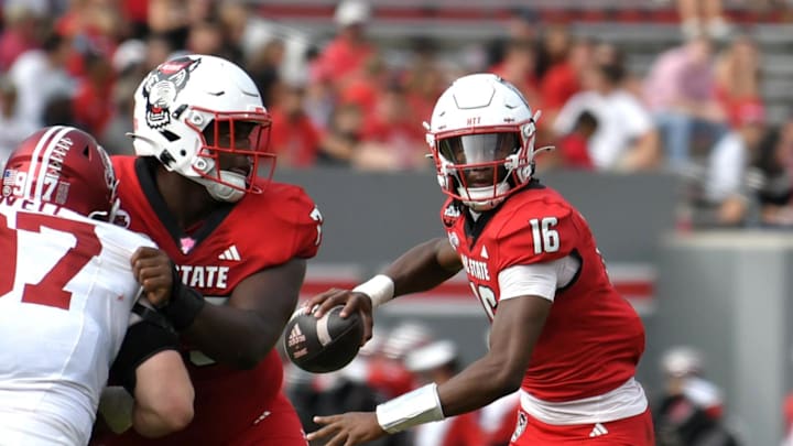 Nov 2, 2024; Raleigh, North Carolina, USA;  North Carolina State Wolfpack quarter back CJ Bailey (16) drops the ball back for a pass during the second quarter against Stanford Cardinals at Carter-Finley Stadium. Mandatory Credit: Zachary Taft-Imagn Images