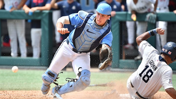 Arizona's Adonys Guzman (18) slides into home plate to score, beating the throw to North Carolina catcher Luke Stevenson (44) . The North Carolina Tar Heels and the Arizona Wildcats met in game two of the NCAA Division 1 Super Regionals in Chapel Hill, N.C. on June 7, 2025.
