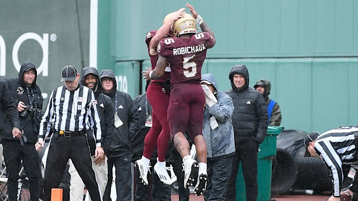 Dec 28, 2023; Boston, MA, USA; Boston College Eagles running back Kye Robichaux (5) celebrates a touchdown against the Southern Methodist Mustangs during the first half at Fenway Park. Mandatory Credit: Eric Canha-Imagn Images