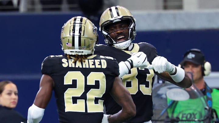 Sep 15, 2024; Arlington, Texas, USA;  New Orleans Saints wide receiver Rashid Shaheed (22) celebrates with New Orleans Saints tight end Juwan Johnson (83) after catching a touchdown  pass during the first quarter against the Dallas Cowboys at AT&T Stadium. Mandatory Credit: Kevin Jairaj-Imagn Images