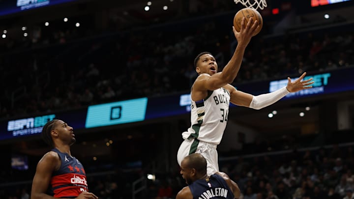 Feb 21, 2025; Washington, District of Columbia, USA: Washington Wizards forward Khris Middleton (32) draws a charge on Milwaukee Bucks forward Giannis Antetokounmpo (34) in the first half at Capital One Arena. Mandatory Credit: Geoff Burke-Imagn Images