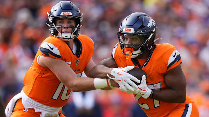 Sep 7, 2025; Denver, Colorado, USA; Denver Broncos running back J.K. Dobbins (27) receives a hand off from quarterback Bo Nix (10) during the second half at Empower Field at Mile High. Mandatory Credit: Ron Chenoy-Imagn Images