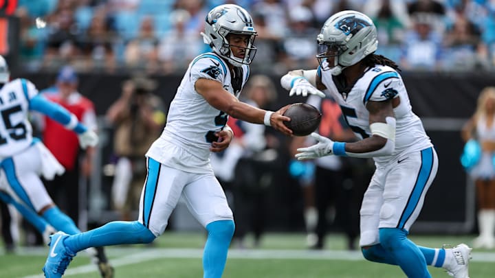 Oct 5, 2025; Charlotte, North Carolina, USA; Carolina Panthers quarterback Bryce Young (9) hands off the ball to Carolina Panthers running back Rico Dowdle (5) during the fourth quarter against the Miami Dolphins at Bank of America Stadium. Oct 5, 2025; Charlotte, North Carolina, USA; Carolina Panthers quarterback Bryce Young (9) hands off the ball to Carolina Panthers running back Rico Dowdle (5) during the fourth quarter against the Miami Dolphins at Bank of America Stadium.