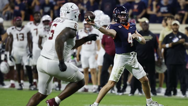 Sep 26, 2025; Charlottesville, Virginia, USA; Virginia Cavaliers quarterback Chandler Morris (4) passes the ball as Florida State Seminoles defensive lineman Darrell Jackson Jr. (6) chases at Scott Stadium. Mandatory Credit: Geoff Burke-Imagn Images