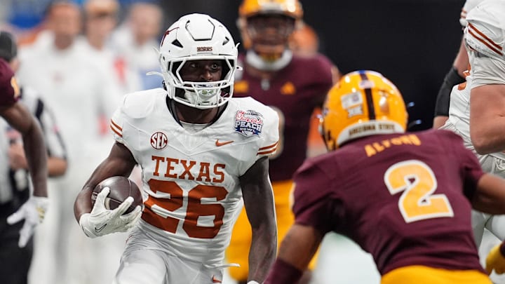 Jan 1, 2025; Atlanta, GA, USA; Texas Longhorns running back Quintrevion Wisner (26) runs with the ball against the Texas Longhorns during the first half of the Peach Bowl at Mercedes-Benz Stadium. Mandatory Credit: Dale Zanine-Imagn Images