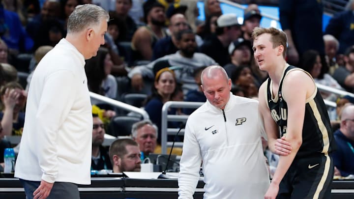 Purdue Boilermakers guard Fletcher Loyer (2) is helped off the court after taking a fall 