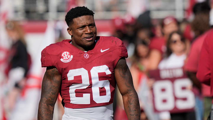 Nov 22, 2025; Tuscaloosa, Alabama, USA; Alabama running back Jam Miller (26) walks to his family with a rose in hand on Senior Day at Saban Field at Bryant-Denny Stadium.