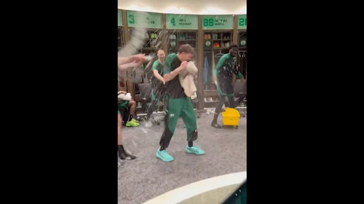 Boston Celtics players douse Baylor Scheierman with water after game vs. Brooklyn Nets on March 18, 2025.