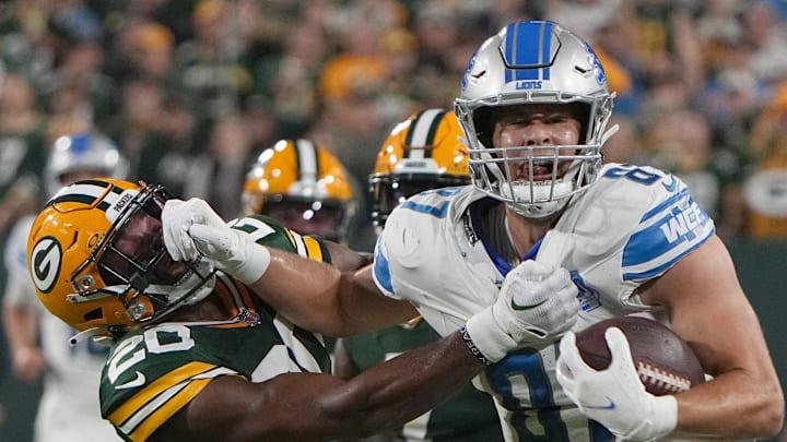 One of the Detroit Lions' young stars, tight end Sam LaPorta (87) stiff-arms former Packers safety Rudy Ford in 2023.