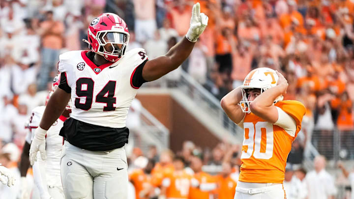 Tennessee place kicker Max Gilbert (90) holds his helmet in disbelief as Georgia defensive lineman Xzavier McLeod (94) celebrates Gilbert's missed field goal in the final seconds of a college football game between Tennessee and Georgia at Neyland Stadium in Knoxville, Tenn., on Sept. 13, 2025.