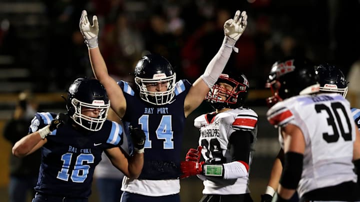 Bay Port High School's Brady Suda (14) celebrates a touchdown during a WIAA Division 1 semifinal versus Muskego High School at the University of Wisconsin Oshkosh's Titan Stadium on Nov. 14, 2025. Bay Port High School's Brady Suda (14) celebrates a touchdown during a WIAA Division 1 semifinal versus Muskego High School at the University of Wisconsin Oshkosh's Titan Stadium on Nov. 14, 2025.