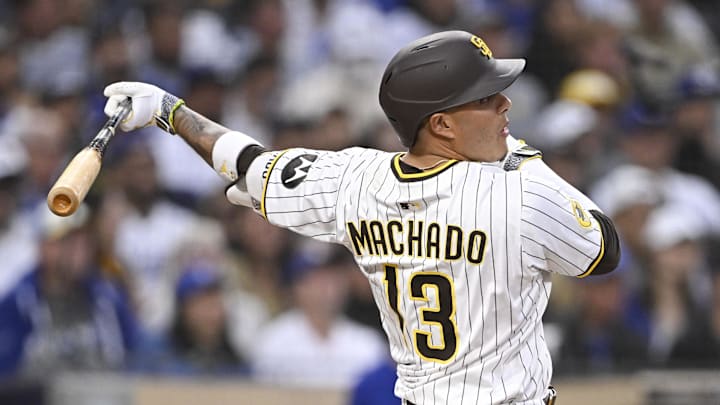 Jun 10, 2025; San Diego, California, USA; San Diego Padres third baseman Manny Machado (13) hits a RBI single during the third inning against the Los Angeles Dodgers at Petco Park. Mandatory Credit: Denis Poroy-Imagn Images Jun 10, 2025; San Diego, California, USA; San Diego Padres third baseman Manny Machado (13) hits a RBI single during the third inning against the Los Angeles Dodgers at Petco Park. Mandatory Credit: Denis Poroy-Imagn Images