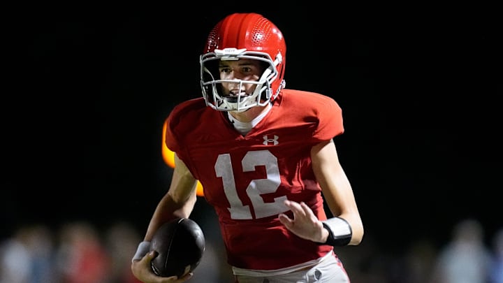 Brentwood Academy's George Macintyre (12) runs the ball against Brentwood during the second half at Brentwood Academy in Brentwood, Tenn., Friday, Aug. 30, 2024.