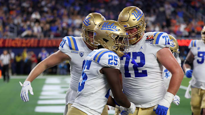 Dec 16, 2023; Inglewood, CA, USA; UCLA Bruins running back TJ Harden (25) celebrates with offensive lineman Garrett DiGiorgio (72) after scoring a touchdown during the third quarter of the LA Bowl at SoFi Stadium. Mandatory Credit: Kiyoshi Mio-Imagn Images