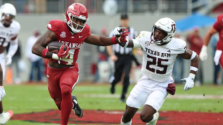 Arkansas Razorbacks running back Mike Washington Jr (4) rushes in the second quarter as Texas A&M Aggies safety Dalton Brooks (25) defends at Donald W. Reynolds Razorback Stadium. Arkansas Razorbacks running back Mike Washington Jr (4) rushes in the second quarter as Texas A&M Aggies safety Dalton Brooks (25) defends at Donald W. Reynolds Razorback Stadium.
