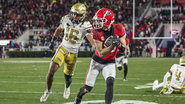 Nov 29, 2024; Athens, Georgia, USA; Georgia Bulldogs wide receiver London Humphreys (16) scores a touchdown behind Georgia Tech Yellow Jackets defensive back Syeed Gibbs (16) during overtime at Sanford Stadium. Mandatory Credit: Dale Zanine-Imagn Images Nov 29, 2024; Athens, Georgia, USA; Georgia Bulldogs wide receiver London Humphreys (16) scores a touchdown behind Georgia Tech Yellow Jackets defensive back Syeed Gibbs (16) during overtime at Sanford Stadium. Mandatory Credit: Dale Zanine-Imagn Images