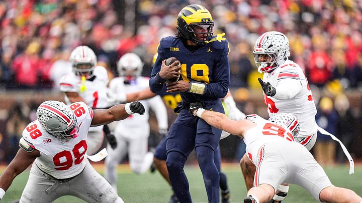 Michigan quarterback Bryce Underwood (19) runs against Ohio State defensive tackle Kayden McDonald (98) and defensive end Caden Curry (92) during the first half at Michigan Stadium in Ann Arbor on Saturday, Nov. 29, 2025.