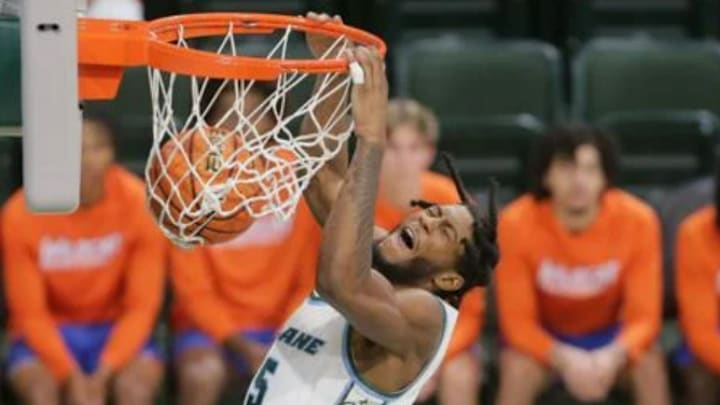 Tulane Green Wave guard Mari Jordan (5) dunks the ball over Joseph Holloway during the first half at Avron B. Fogelman Arena on the Tulane campus in New Orleans, Monday, Nov. 4, 2024.