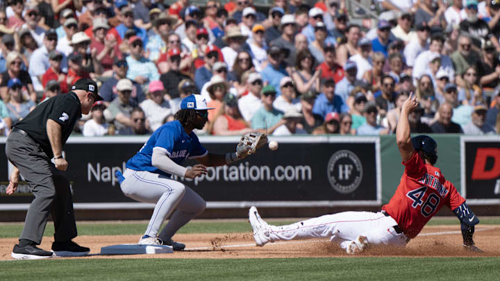 Feb 23, 2025; Fort Myers, Florida, USA; Toronto Blue Jays third baseman Charles McAdoo (84) just misses the tag on Boston’s Roman Anthony (48) during the first inning of their game at JetBlue Park at Fenway South. Mandatory Credit: Chris Tilley-Imagn Images Feb 23, 2025; Fort Myers, Florida, USA; Toronto Blue Jays third baseman Charles McAdoo (84) just misses the tag on Boston’s Roman Anthony (48) during the first inning of their game at JetBlue Park at Fenway South. Mandatory Credit: Chris Tilley-Imagn Images