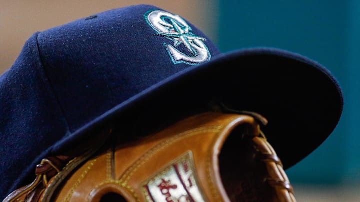 A Seattle Mariners hat sits on top a mitt before a game against the Texas Rangers on June 4, 2016, at Globe Life Field in Arlington, Texas.