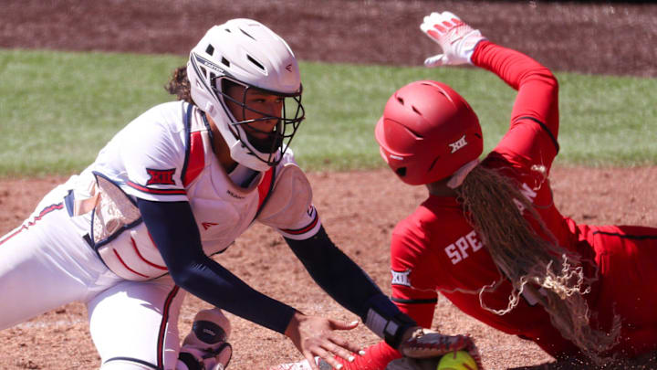 Texas Tech's Desirae Spearman scores a run around Arizona catcher Sydney Stewart during a Big 12 Conference softball game, Saturday, March 14, 2026, at Rocky Johnson Field.