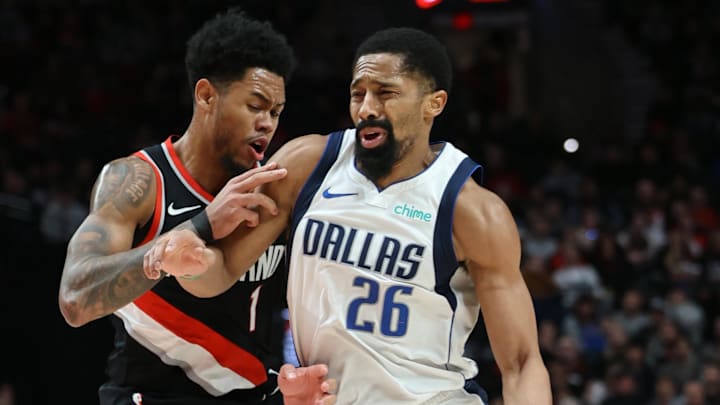 Dec 1, 2024; Portland, Oregon, USA;  Dallas Mavericks guard Spencer Dinwiddie (26) dribbles the bal past Portland Trail Blazers guard Anfernee Simons (1) in the second half at Moda Center. Mandatory Credit: Jaime Valdez-Imagn Images