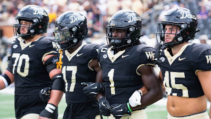 Wake Forest Demon Deacons captains Devin Kylany (70), Zamari Stevenson (17), Demond Claiborne (1), and Nick Andersen (45) come together before kickoff against Western Carolina University on Saturday, Sept. 6, at Allegacy Federal Credit Union Stadium in Winston-Salem, North Carolina Wake Forest Demon Deacons captains Devin Kylany (70), Zamari Stevenson (17), Demond Claiborne (1), and Nick Andersen (45) come together before kickoff against Western Carolina University on Saturday, Sept. 6, at Allegacy Federal Credit Union Stadium in Winston-Salem, North Carolina