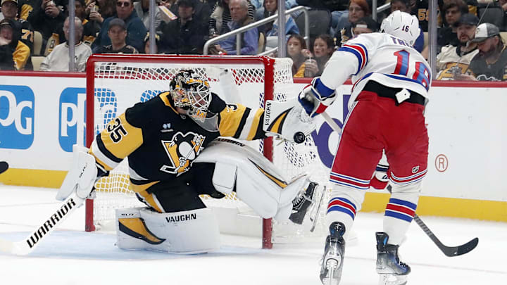 Oct 9, 2024; Pittsburgh, Pennsylvania, USA;  Pittsburgh Penguins goaltender Tristan Jarry (35) makes a glove save against New York Rangers center Vincent Trocheck (16) during the third period at PPG Paints Arena. Mandatory Credit: Charles LeClaire-Imagn Images