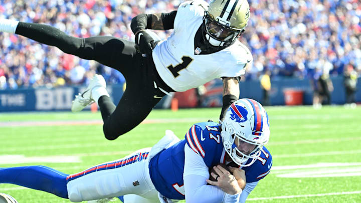Sep 28, 2025; Orchard Park, New York, USA; Buffalo Bills quarterback Josh Allen (17) dives for a touchdown past New Orleans Saints cornerback Alontae Taylor (1) during the third quarter at Highmark Stadium. 