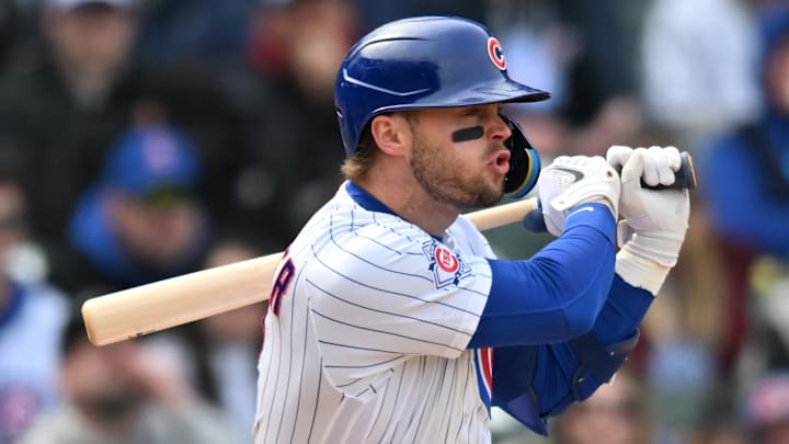 Apr 11, 2026; Chicago, Illinois, USA; Chicago Cubs second baseman Nico Hoerner (2) hits a sacrifice RBI ground ball against the Pittsburgh Pirates during the fifth inning at Wrigley Field.