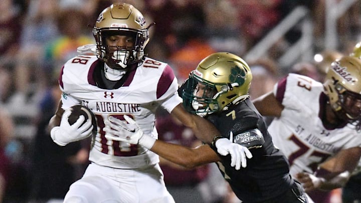 St. Augustine's Somourian Wingo (18) tries to get away from Nease Panthers Adriann Reyes (7) on a late second quarter run. The St. Augustine Yellow Jackets traveled to Nease High School's Panther Stadium for Friday night's Saint Johns County high school football rivalry game October 6, 2023. St. Augustine's Somourian Wingo (18) tries to get away from Nease Panthers Adriann Reyes (7) on a late second quarter run. The St. Augustine Yellow Jackets traveled to Nease High School's Panther Stadium for Friday night's Saint Johns County high school football rivalry game October 6, 2023.