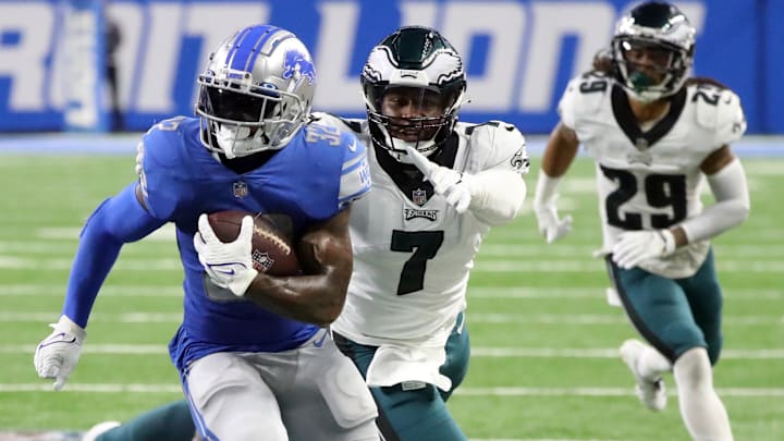 Sep 11, 2022; Detroit, Michigan, USA; Detroit Lions running back D'Andre Swift (32) runs by Philadelphia Eagles linebacker Haason Reddick (7) during second half action at Ford Field.