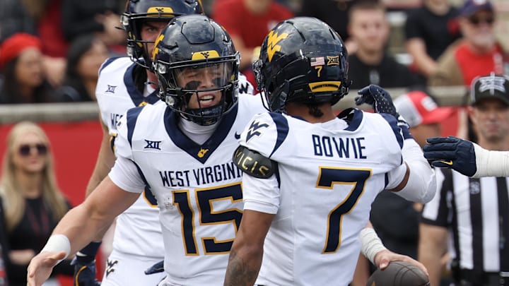 Nov 1, 2025; Houston, Texas, USA; West Virginia Mountaineers quarterback Scotty Fox Jr. (15) celebrates his touchdown with wide receiver Jarod Bowie (7) and teammates against the Houston Cougars in the first half at TDECU Stadium. Mandatory Credit: Thomas Shea-Imagn Images