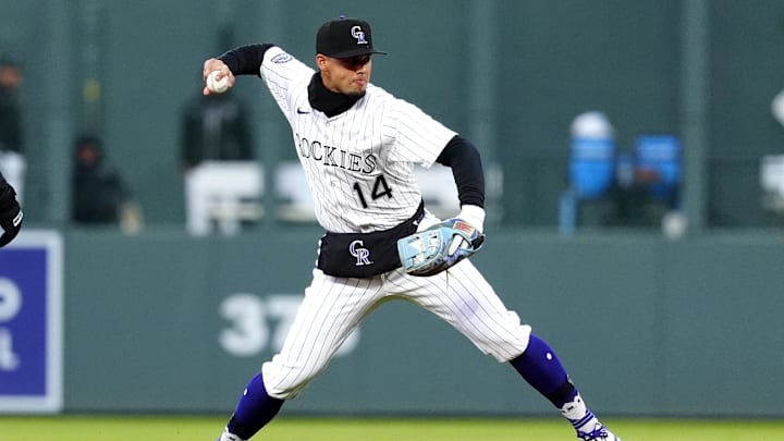 Apr 5, 2025; Denver, Colorado, USA; Colorado Rockies shortstop Ezequiel Tovar (14) fields the ball in the fifth inning against the Athletics at Coors Field. Mandatory Credit: Ron Chenoy-Imagn Images