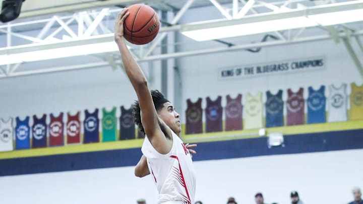 Newport's Taylen Kinney (0) goes up for two of his 13 points in the first half against Washington County at Wednesday's 2023 King of the Bluegrass basketball tournament at Fairdale High School. Dec. 20, 2023