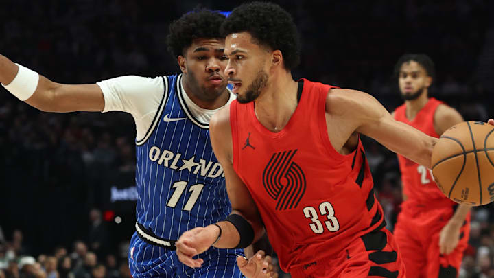 Dec 23, 2025; Portland, Oregon, USA;  Portland Trail Blazers forward Toumani Camara (33) dribbles the ball against Orlando Magic guard Jase Richardson (11) during the first half at Moda Center. Mandatory Credit: Jaime Valdez-Imagn Images