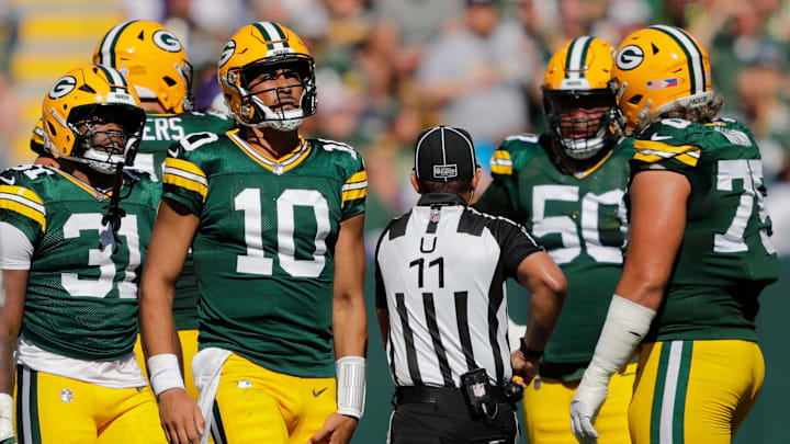 Green Bay Packers quarterback Jordan Love (10) grabs his leg after running the ball against the Minnesota Vikings during their football game Sunday, September 29, 2024, at Lambeau Field in Green Bay, Wisconsin.