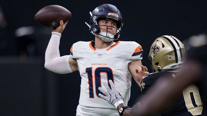 Aug 23, 2025; New Orleans, Louisiana, USA;  Denver Broncos quarterback Bo Nix (10) throws against New Orleans Saints safety Ugo Amadi (0) during the first half at Caesars Superdome. 