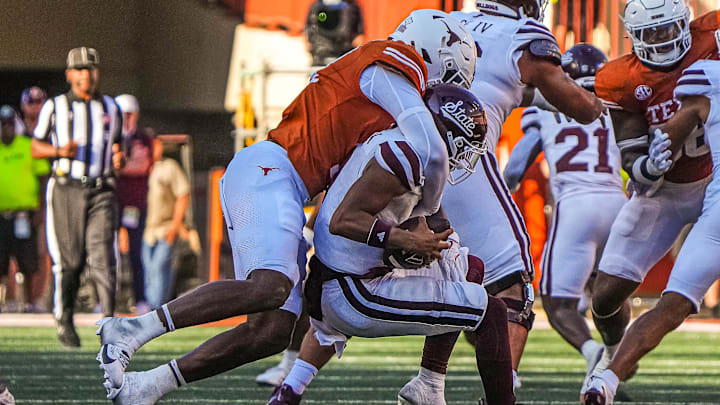 Mississippi State quarterback Michael Van Burn Jr. (0) is sacked by Texas Longhorns edge rusher Colin Simmons (11) during the game at Darrell K Royal-Texas Memorial Stadium in Austin Saturday, Sept. 28, 2024.