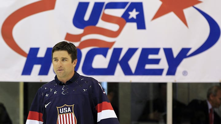 Aug 27, 2013; Arlington, VA, USA; Former  NHL player and Olympic team member Chris Drury walks onto the ice during a ceremony unveiling the 2014 Olympic hockey jersey as part of the 2013 U.S. men's national team camp at Kettler Capitals Iceplex. Mandatory Credit: Geoff Burke-Imagn Images
