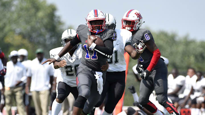DeMatha Stags quarterback runs the ball into the end zone against the Miami Central Rockets