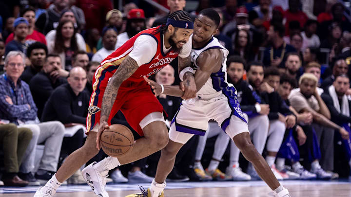 Apr 19, 2024; New Orleans, Louisiana, USA; Sacramento Kings guard De'Aaron Fox (5) attempts to steal the ball from New Orleans Pelicans forward Brandon Ingram (14) in the second half during a play-in game of the 2024 NBA playoffs at Smoothie King Center. Mandatory Credit: Stephen Lew-USA TODAY Sports