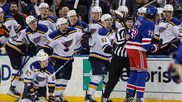 Nov 25, 2024; New York, New York, USA; New York Rangers center Matt Rempe (73) is pulled away by a linesman after a hit on St. Louis Blues left wing Jake Neighbours (63) that was called for roughing during the third period at Madison Square Garden. Mandatory Credit: Danny Wild-Imagn Images